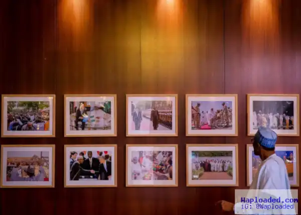 President Buhari admires photos on his corridor